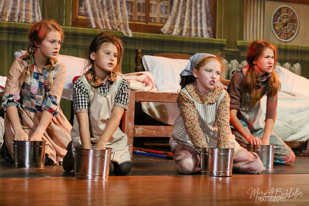 Annie — Miss Hannigan scolding a group of orphan girls in the orphanage set