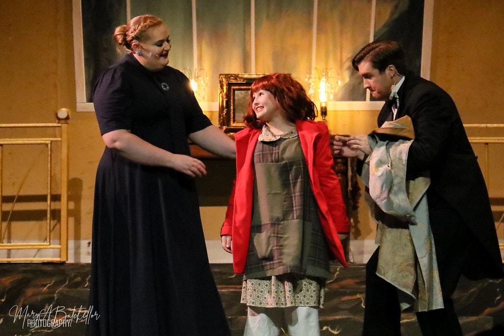 Annie — Grace Farrell and Oliver Warbucks bow to Annie in the Warbucks mansion parlor