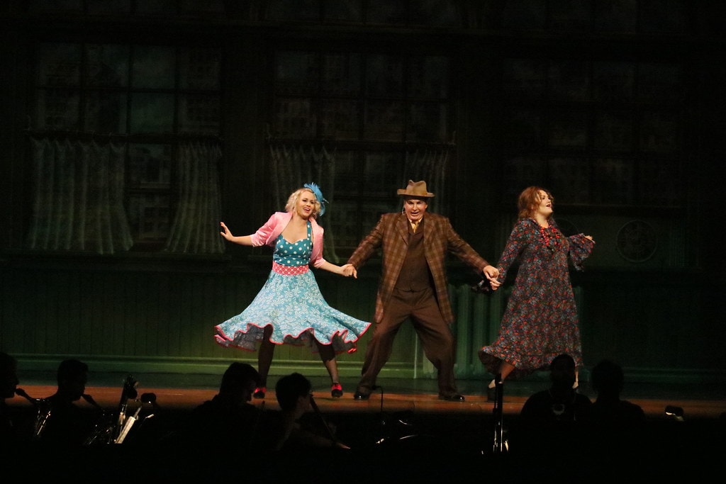 Annie — Lily St. Regis, Rooster, and Miss Hannigan dance together with arms wide — second angle