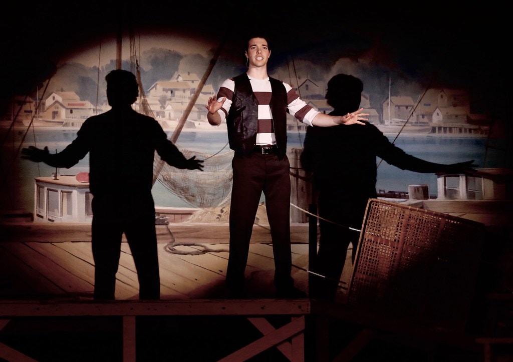 Billy Soliloquy spotlight with silhouetted figures — Carousel