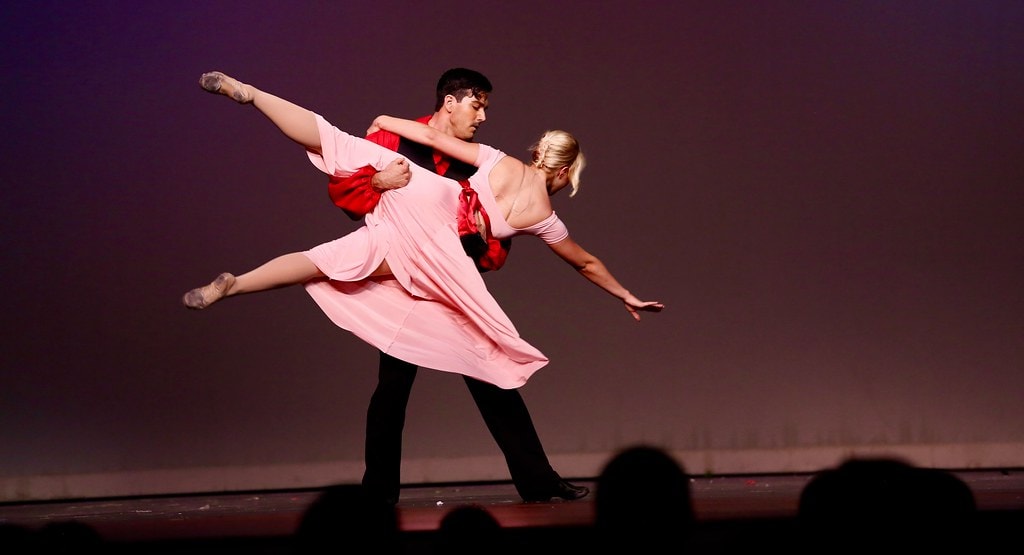 Billy and Julie ballet lift in pink and red costumes — Carousel
