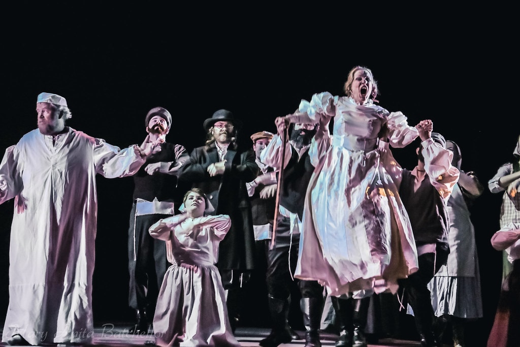Fiddler on the Roof — the full ensemble in nightgowns and period costumes performs the chaotic dream sequence under dramatic dark lighting