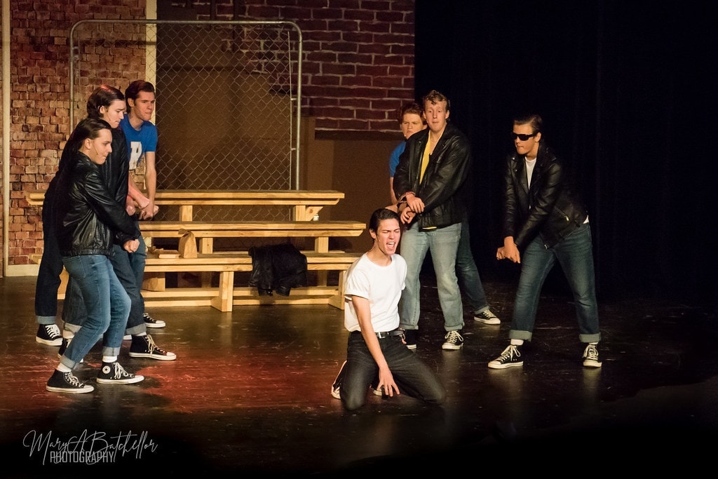 Grease — T-Birds surrounding Danny on his knees in confrontation scene