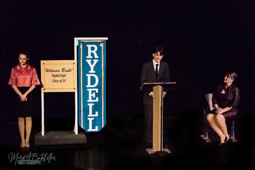 Grease — Rydell High Class of 59 reunion scene with podium