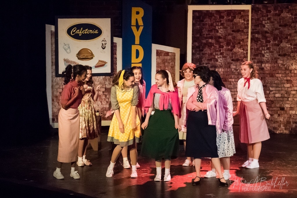Grease — full female cast gathering outside Rydell cafeteria