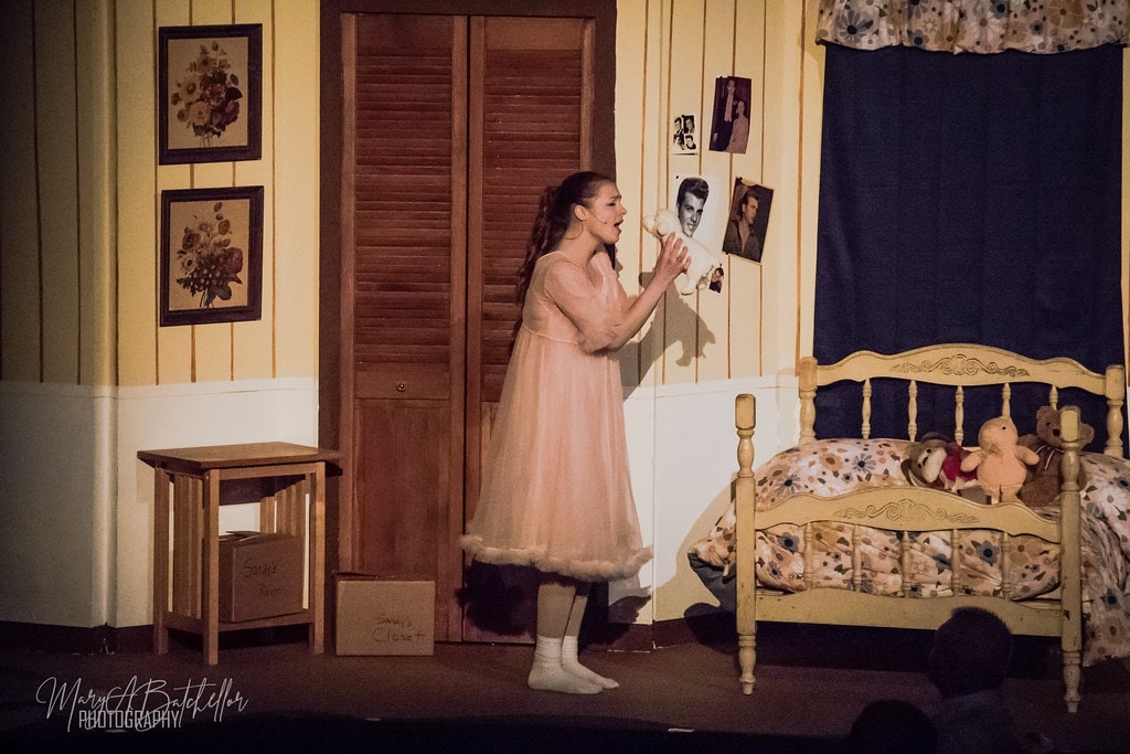 Grease — Sandy in pink nightgown singing to a photo of Danny