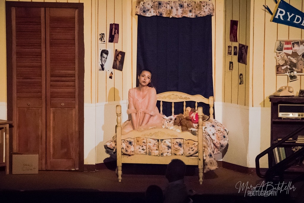 Grease — Sandy alone in her Rydell bedroom set in pink robe