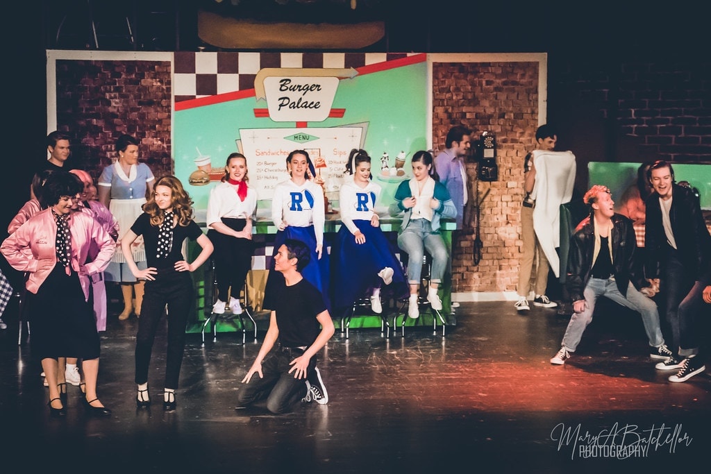 Grease — full Burger Palace scene with cheerleaders on counter