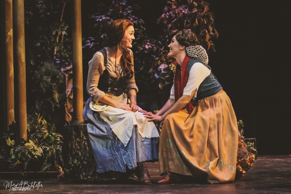 Into the Woods — Little Red Riding Hood and the Baker's Wife crawl on the stage floor in the dark enchanted forest