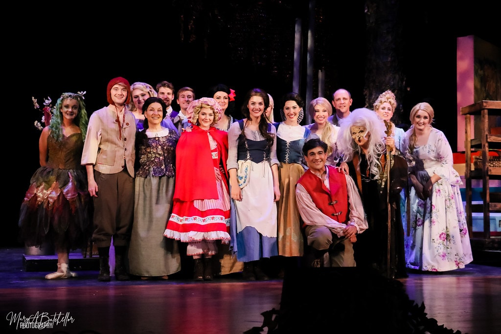 Into the Woods — the full company poses for a cast photo before the forest set