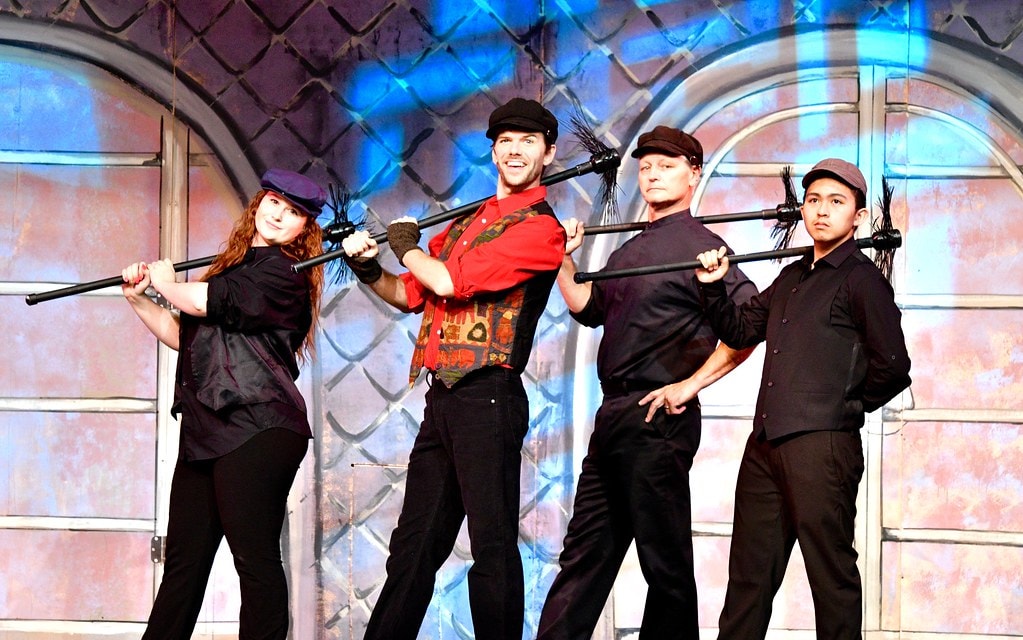 Chimney sweeps with brooms on rooftop — Mary Poppins