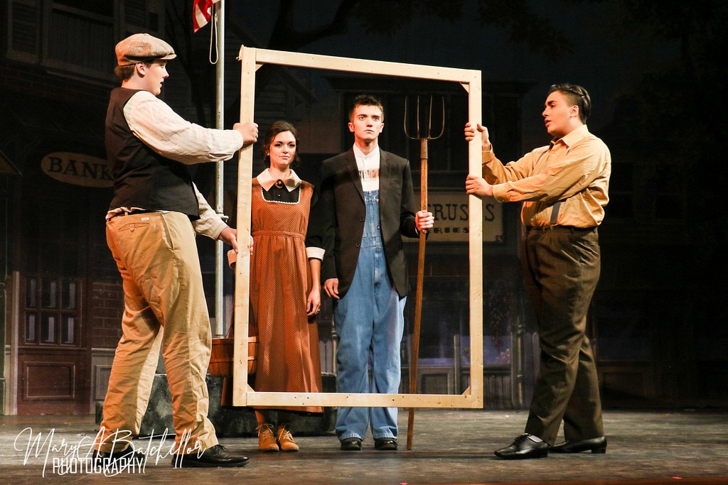 The Music Man — four actors on the River City main street set