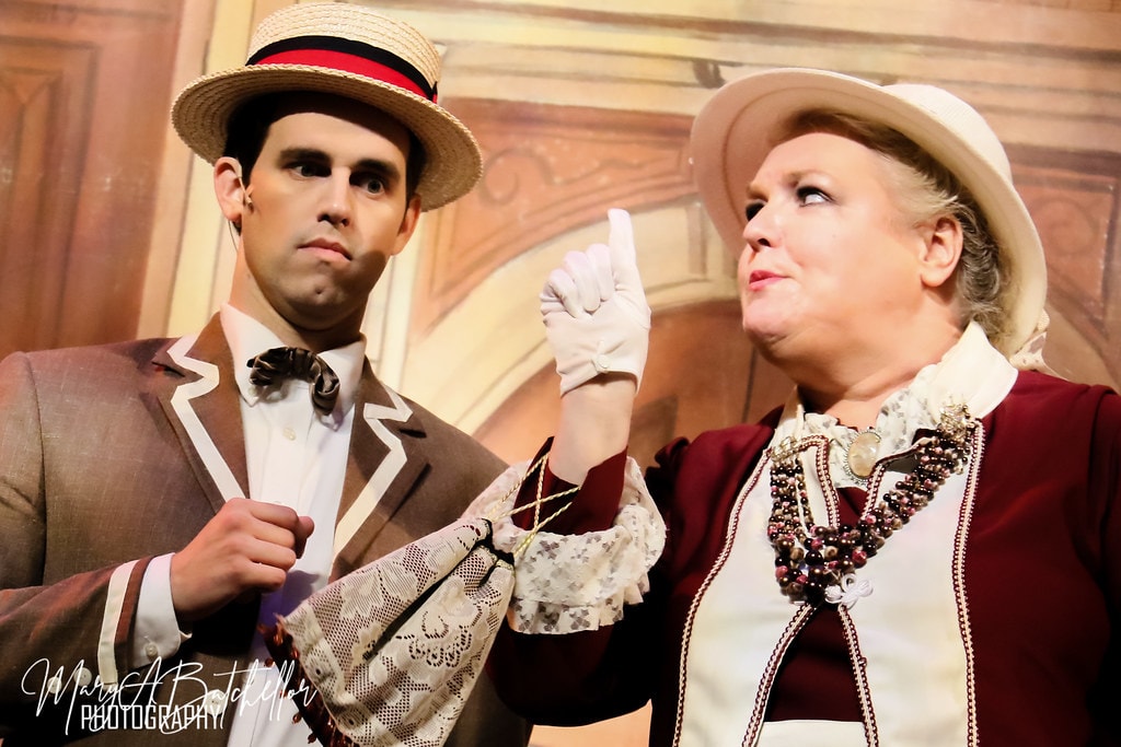 The Music Man — Harold Hill beside Eulalie as she wags a gloved finger at him