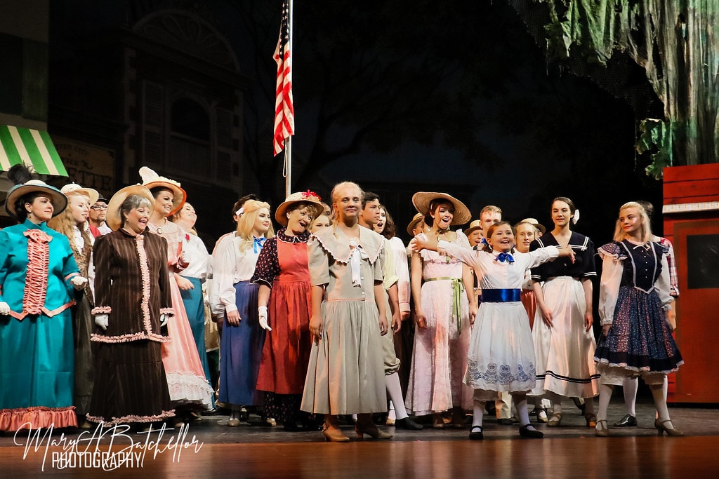 The Music Man — the full River City ensemble sings together before the American flag