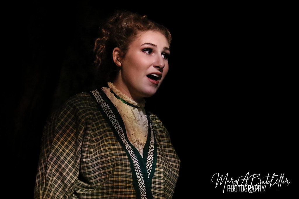 The Music Man — Marian in a plaid dress sings a close-up solo in a dramatic spotlight
