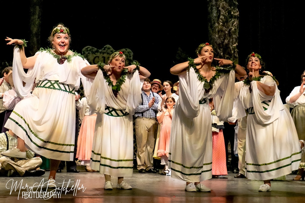 The Music Man — four women in white Greek-style robes with laurel wreaths perform a comedic number