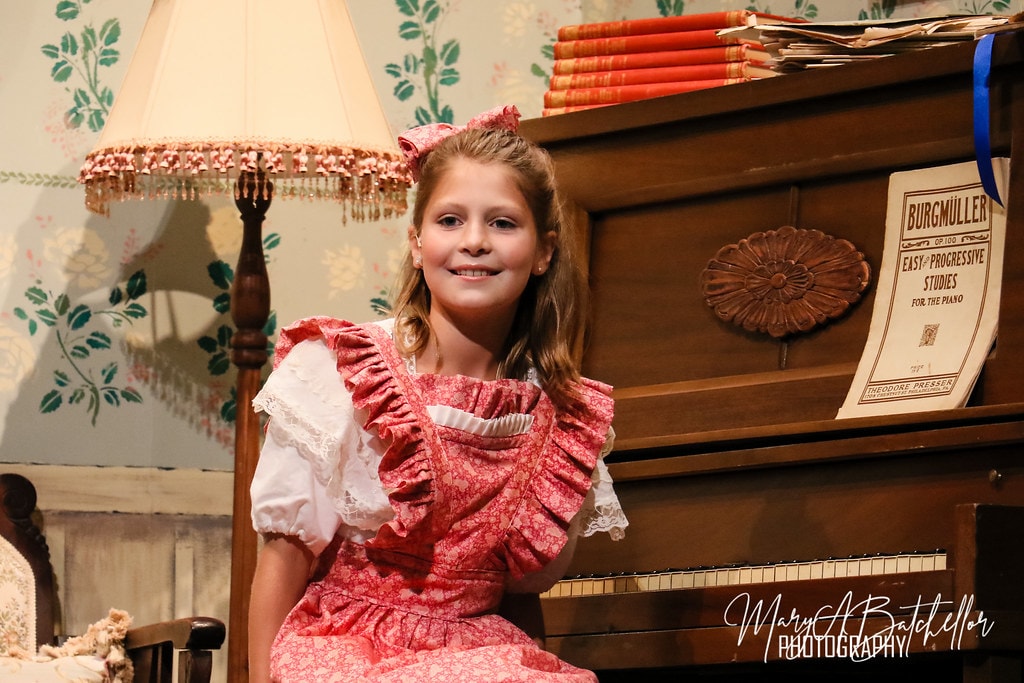The Music Man — Amaryllis smiling at the upright piano