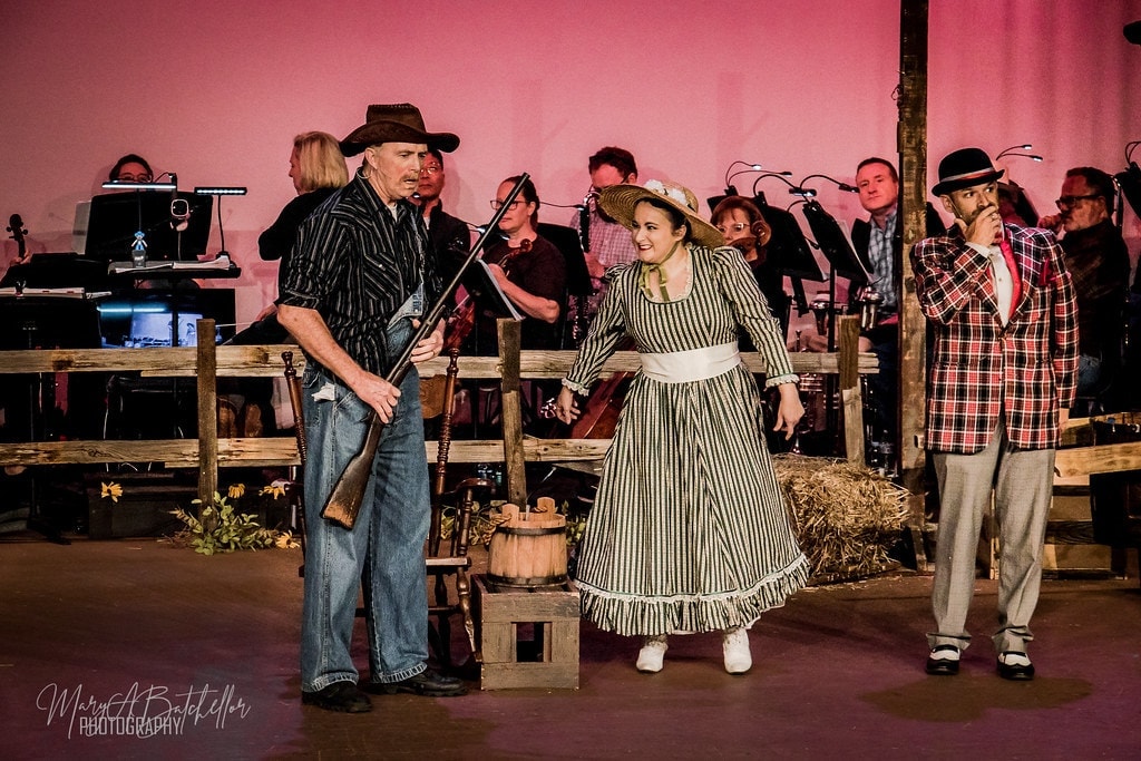 Oklahoma! — Ado Annie and Will Parker seated on crate