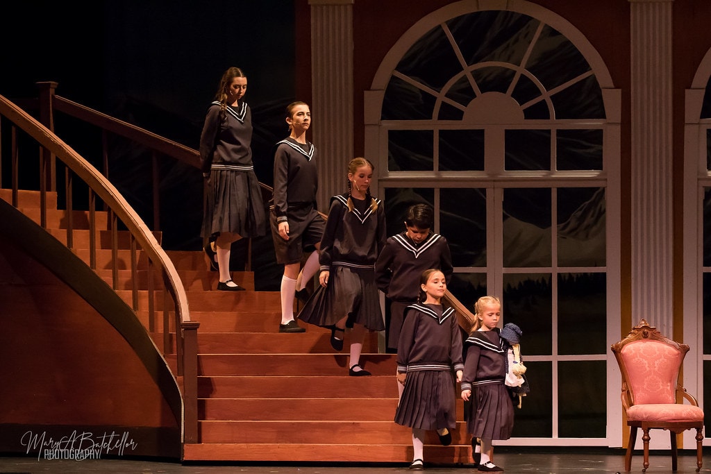 The Sound of Music — five von Trapp children in sailor uniforms descending the grand staircase