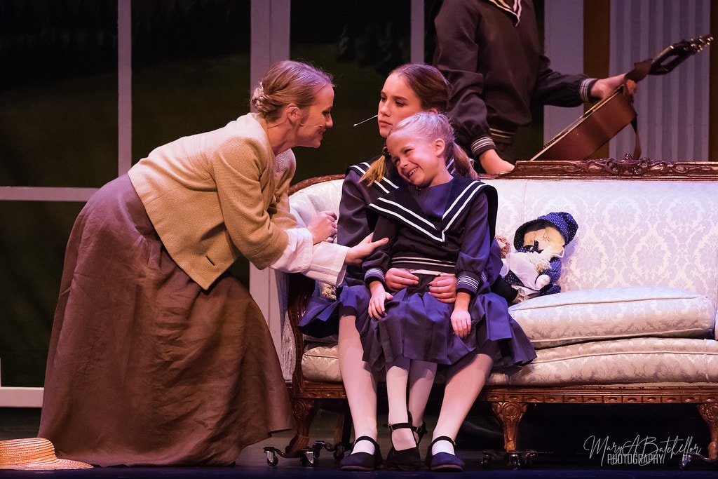 The Sound of Music — Maria kneeling warmly with the youngest von Trapp child