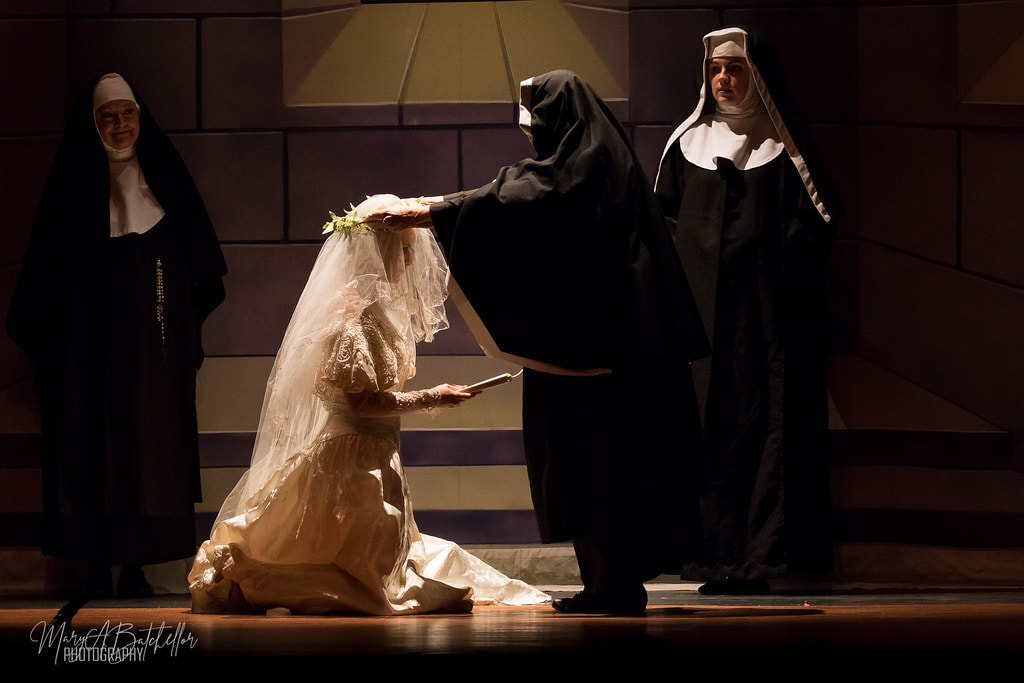 The Sound of Music — Maria in wedding gown kneeling as the Mother Abbess places her veil