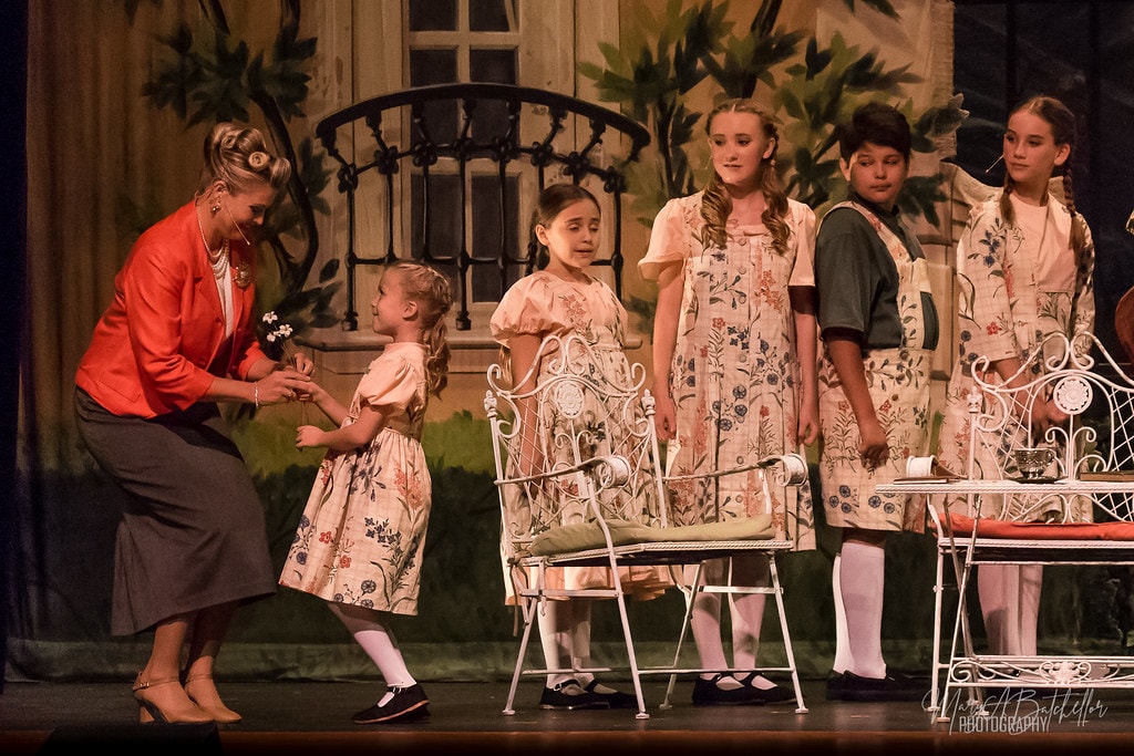 The Sound of Music — all seven von Trapp children in floral costumes with two adult men