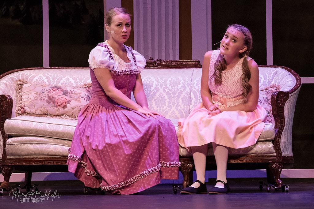 The Sound of Music — Captain von Trapp and Maria holding hands with silver tea service behind them