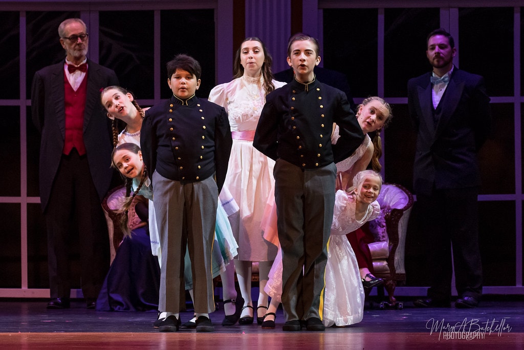 The Sound of Music — full adult ensemble performing elegant ballroom dance before grand arched windows