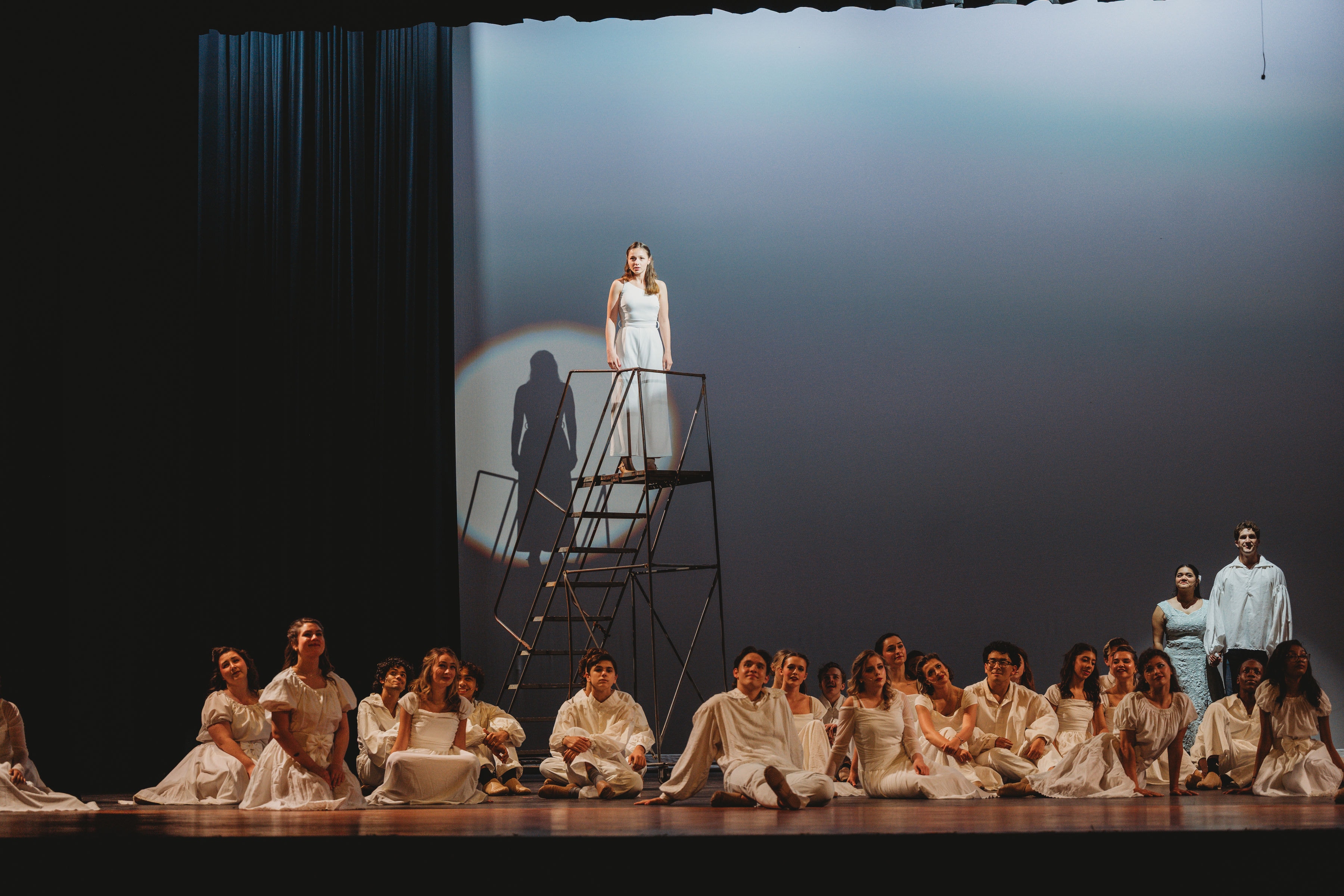 West Side Story 2026 - full ensemble with soloist elevated on scaffold