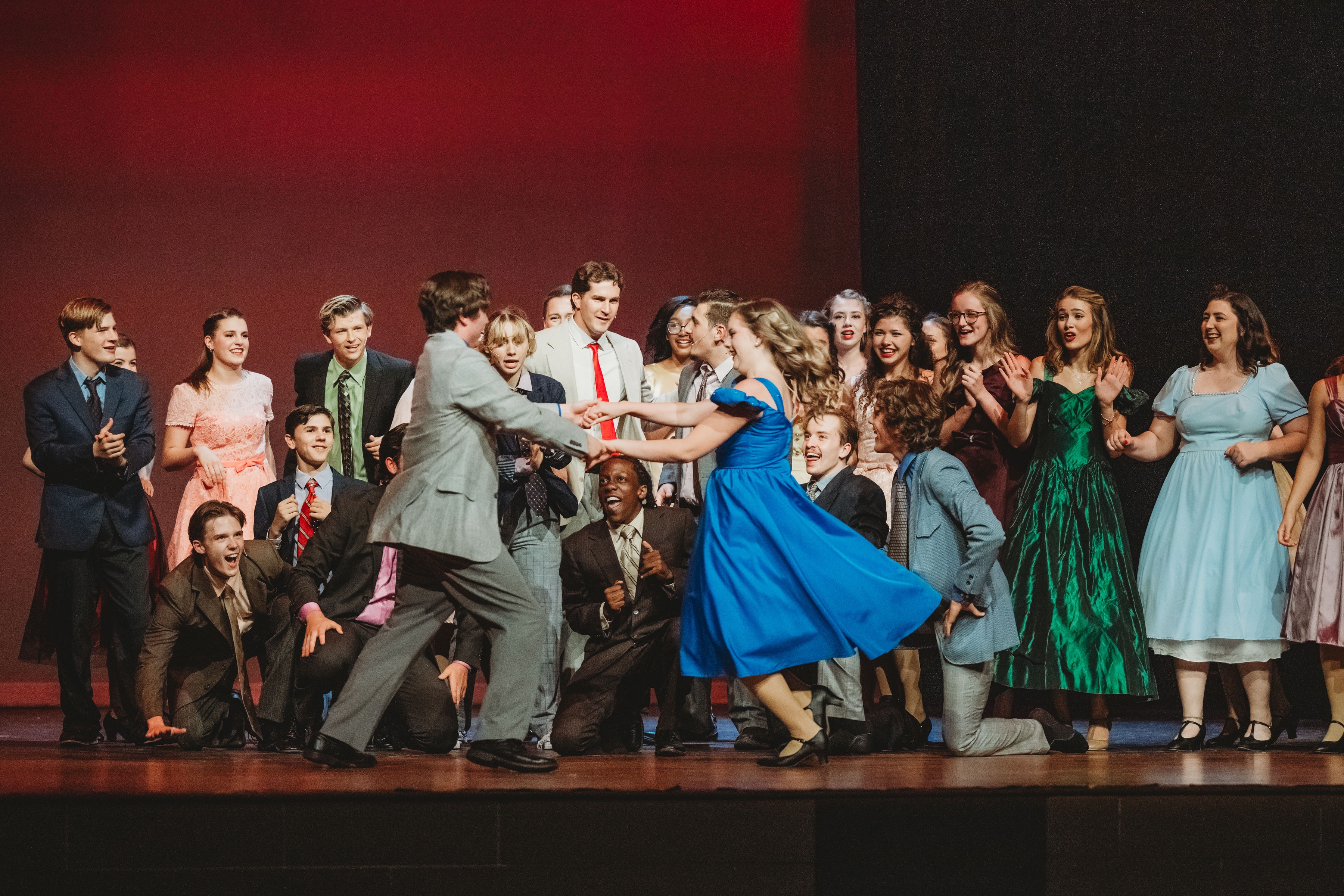 West Side Story 2026 - full ensemble dance number at the gym with red backdrop