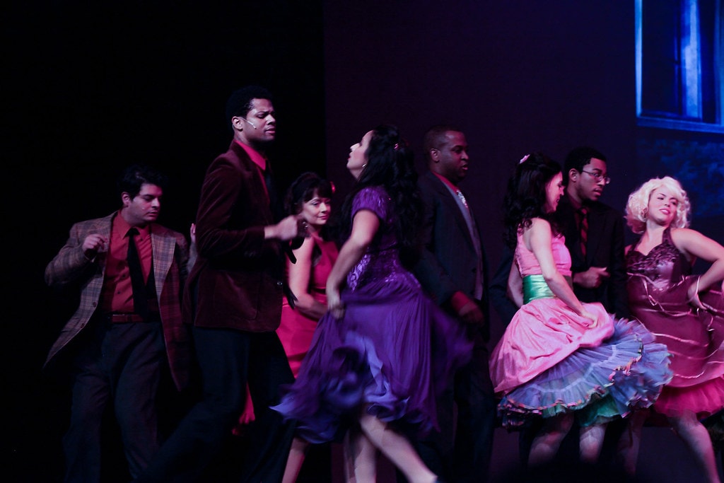 Purple-lit ensemble dance number — West Side Story