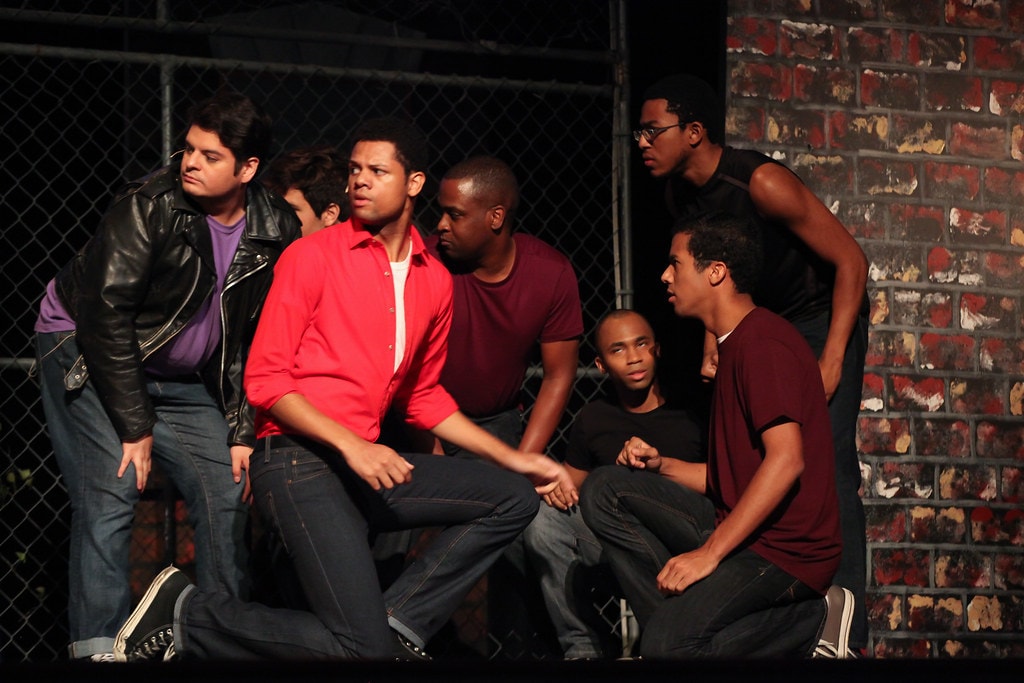 Cast in costume performing — West Side Story